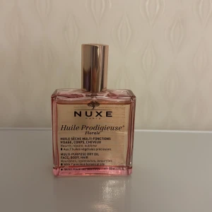 Nuxe Huile Prodigieuse Florale 100ml - Multi-purpose dry oil för ansikte, kropp och hår. Innehåller 7 botaniska oljor och ger näring, reparerar och förskönar. Volym: 100 ml. Passar alla hudtyper.