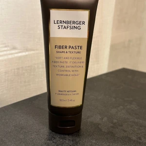 Lernberger Stafsing Fiber Paste 100ml - Fiber Paste från Lernberger Stafsing ger textur, volym och definition till håret. Innehåller sheasmör, arganolja och broccolifröolja för vård och skydd. Mjuk, flexibel formula som är lätt att tvätta ur och passar för styling av både kort och medellångt hår.