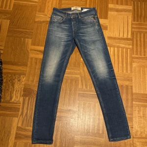 Blå Replay Willbi jeans slim fit - Snygga blå jeans från Replay, modell Willbi med regular slim fit. Storlek W27, passar perfekt om man har andra jeans med liknande storlek! Inga tecken på slitningar, använda extremt lite. Det finns snygga slitningar som är där när de köps.
