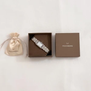 Mockberg Timeless Silver Watch - ♡ Timeless Silver Watch from Mockberg. ♡ Never used. ♡ Comes in original box. ♡ Case and bracelet: Silver-plated stainless steel ♡ Color of dial: White ♡ Glass: Shock-resistant mineral glass ♡ Dial diameter: 19x28 mm ♡ Size: Adjustable bracelet ♡ Width of bracelet: 13 mm ♡ Water resistance: 3 ATM (can withstand water pressure equivalent to a depth of 30 meters) Please send me respectable offers! 🩷 ˚ʚ♡ɞ˚🦢