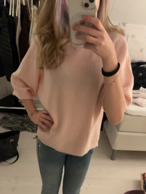 Ljusrosa stickad tröja med kort ärm - Gullig rosa tröja från lager. Använd få gånger. Den är i bra skick.