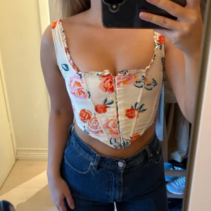 Blommig korsettopp - Supersöt korsettopp från Stradivarius. Strl s, passar nog även xs💕 i använt skick