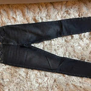 Svarta jeans från BOSS - Snygga svarta skinny jeans från BOSS med klassisk femficksdesign och diskreta sömmar. Jeansen har en mörk tvätt och silverfärgade detaljer vid knappen.