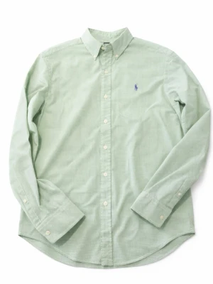 Grön skjorta från Ralph Lauren - Klassisk grön skjorta från Ralph Lauren med diskret rutmönster och broderad logga på bröstet. Skjortan har lång ärm, knappar framtill och button-down krage. Tillverkad i mjuk bomull för en bekväm känsla.