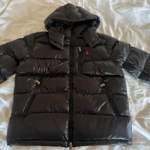 Svart pufferjacka från Ralph Lauren - Säljer en helt ny Polo Ralph Louren Jacka, aldrig använd.                                                                       Storlek XL                                                                  Skriv vid intresse 