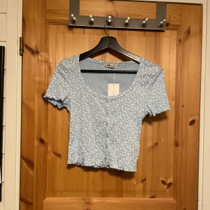 Helt ny blommig croppad tröja från märket FB Sister - Säljer en helt ny blommig croppad tröja från märket FB Sister i storlek S.