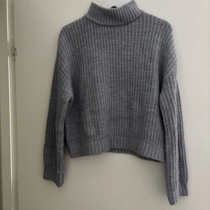 Grå polotröja från Kappahl - Snygg grå polotröja från Kappahl i stickad bomullsmix. Tröjan har ribbad polokrage, långärmad design och ett grovt stickat mönster som ger en chill och trendig vibe. Perfekt för lager-på-lager under kyliga dagar. Använd max 3 gånger och är i som nyskick. Pris kan diskuteras💗