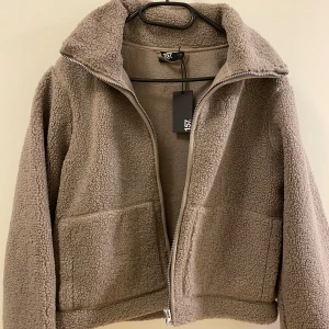 fuzzy jacket  - brand new with tags fluffy jacket in gray color