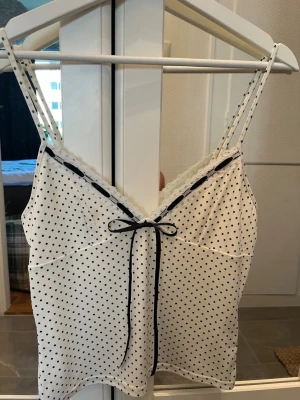 Prickigt linne  - Supergulligt prickigt linne med söt rosett från urban outfitters. Knappt använd 