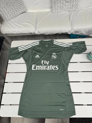 Real Madrid Adizero matchverision tröja - Säljer denna ÄKTA Real Madrid tröjan i en grön färg. Säljer då jag börjar växa ur den. Storlek S men passar som en M. Äkta Adidas Adizero (matchversion). Bra skick använd ett par gånger. Skriv vid frågor! :)