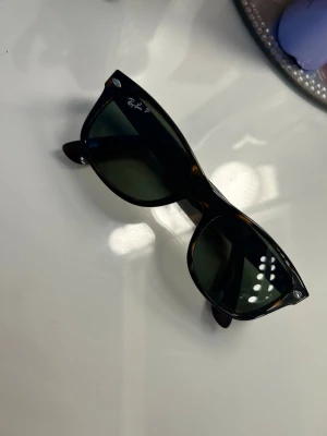 Ray-Ban New Wayfarer solglasögon - Aldrig använda Ray-Ban-bågar i brun/svart sköldpaddsfärg. Modellen är RB 2132 New Wayfarer, storlek 52/18. Med Polariserat glas. 