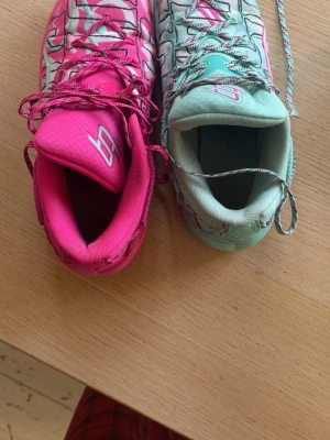Basketskor: Puma Stewie 4 Timeless sneakers - Puma Stewie 4 Timeless sneakers i storlek 41. Ena skon är mintgrön och den andra är rosa, båda med mönstrade skosnören och vita detaljer. Snygg sportig siluett och tillverkade i syntetmaterial, perfekta för dig som vill sticka ut. Bara 1 år gammla!