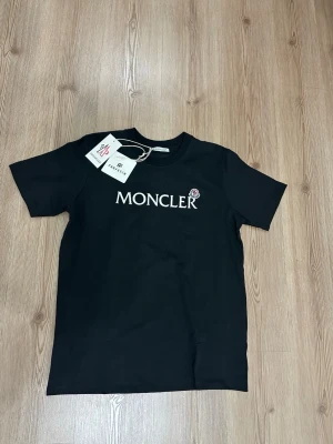 Svart Moncler t-shirt med logga - Mått kan skickas vid intresse! Öppen för frågor och byten! Pris kan diskuteras vid snabb affär. 