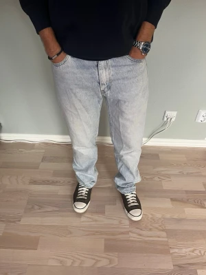 Levi’s 555 Jeans Light Wash W29 L32 - Levi’s 555 i ljusblå denim med klassisk straight fit. Tidlös modell med knappgylf och klassiska Levi’s-detaljer. En mångsidig jeansmodell som passar perfekt till både t-shirt, hoodie, skjorta eller stickat.  Skick: fint skick, inga hål eller fläckar Storlek: W29 L32 Passform: 555 / straight fit