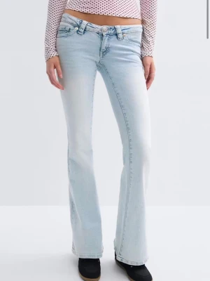 Ljusblå bootcut jeans med broderade fickor - Säljer ett par ljusblå bootcut jeans med snygg broderad detalj på bakfickorna. Jeansen har klassisk femficksmodell, låg midja och är tillverkade i denim med lite stretch för skön passform. Perfekta för dig som gillar retrovibbar och vill ha en avslappnad look. Säljer eftersom att de är för stora ❤️