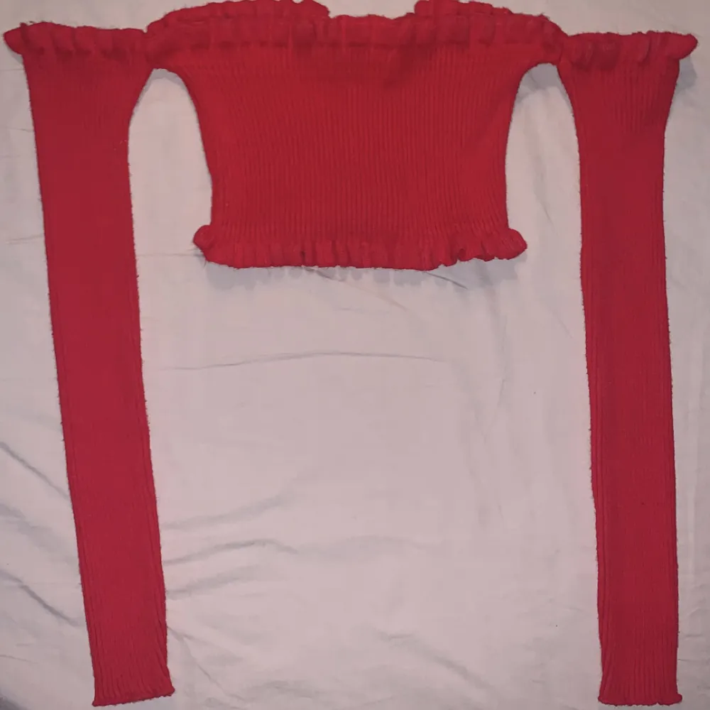 En stretchig, röd och mysig stickad croptop tröja. . Stickat.