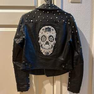 Super funky leather jacket with plenty of studs and crystals.