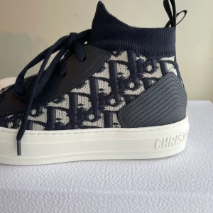 Dior sneakers - Intressekoll på mina Dior sneakers i modellen WALK'N'DIOR SNEAKER. Använda men i jättebra skick. Inköpta från Diors hemsida, nypriset är ca 11.600kr. Ingår dustbag, extra skosnören, m.m. 🖤