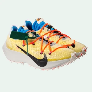 Off White X Nike Vapor Street - Off WhiteX Nike Vapor Street Off-White™ x Nike Vapor Street in yellow. Nylon and synthetic material overlay and hiking-inspired lace-up closure in orange. Black lace-up closure. White spiked sole. Black swoosh at one side and silver swoosh at other side.
