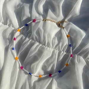 Alida necklace - Alida necklace är ett pärlhalsband med blommor i blått, rosa och orange. 💙💗🧡Detta halsband passar perfekt till alla sommarens outfits! Justerbart med förlängningskedja och karbinhake, standardfrakt 19:-