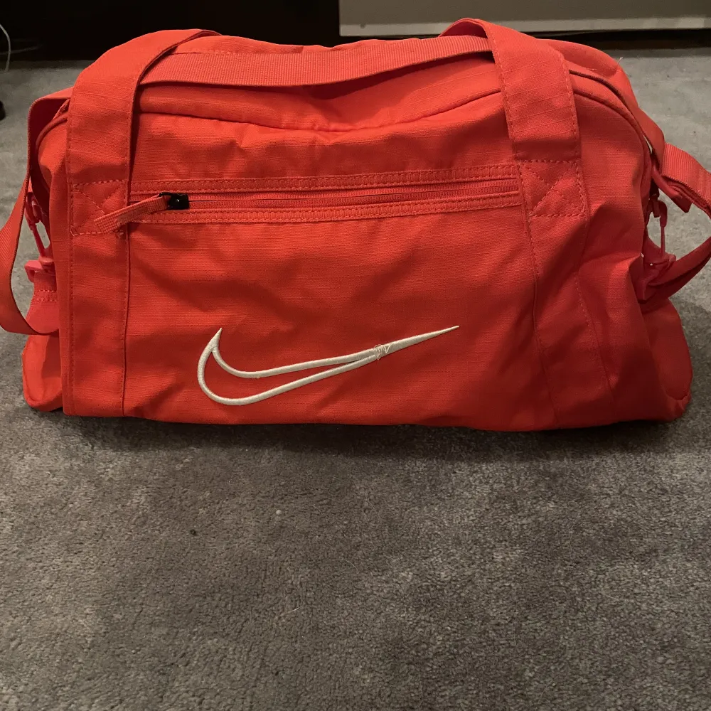 En stor röd sport väska. Väskan är knappt använd. . Väskor.