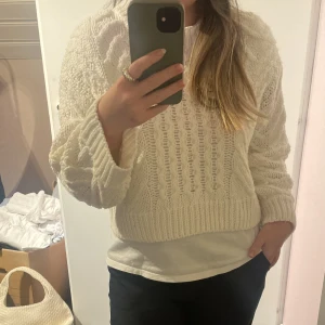 Vit mönstrad stickad - Vi stickad tröja med mönster i kortare modell. Är i fint skick. Hör av dig vid frågor eller för fler bilder💗