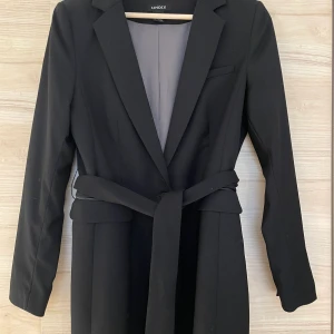 Svart kavaj  - Svart kavaj med knytskärp i midjan.