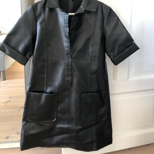 Skinnklänning - Superfin svart klänning i fakeskinn. Eftersom det var längesen jag köpte den minns jag inte vart den är ifrån och klänningen saknar märkeslapp.