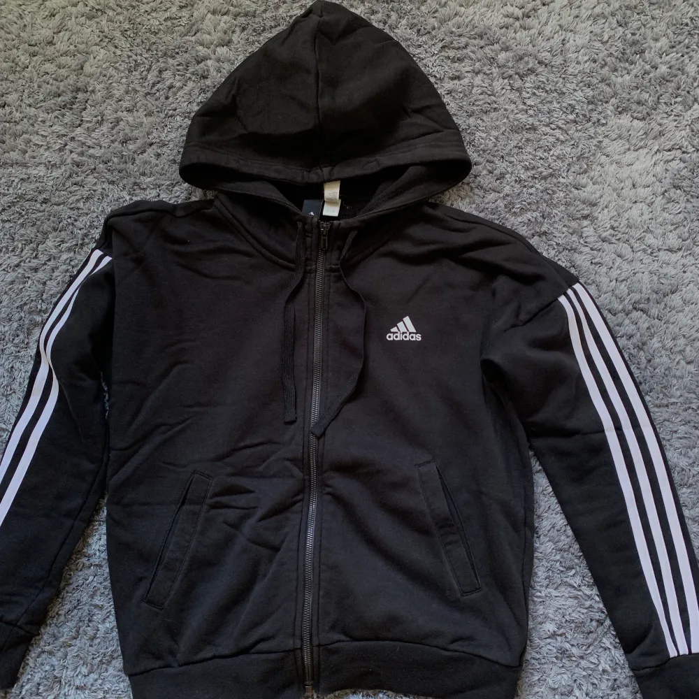 Säljer denna Adidas hoodie från stadium. Använd fåtal gånger, är i fint skick!  Vid intresse tveka inte att kontakta!🤩. Hoodies.