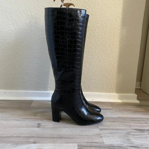 Knä höga stövlar med klack  - Svarta stövlar med klack som går upp till knäna. Använda en gång. Nypris 700kr storlek 38
