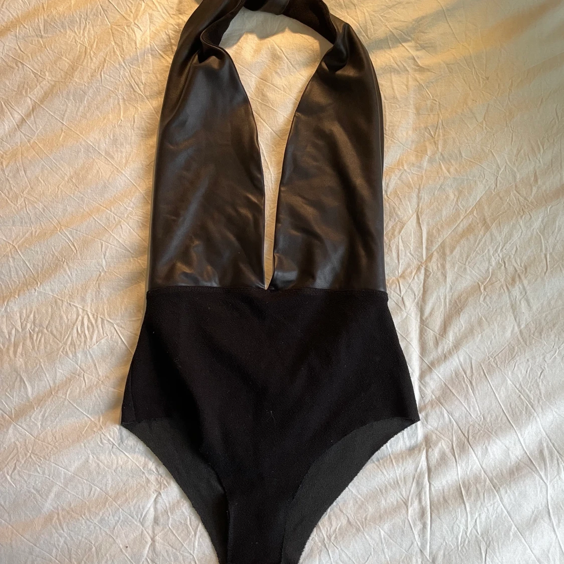 Subdued halter black leather top M