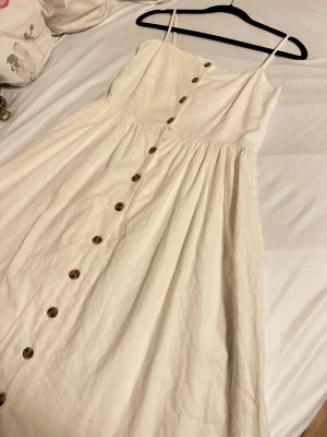 Beiges/vit klänning! - Skriv innan köp! Användt 1 gång och har inga fel (10/10) Färgen är en jätte ljus beiges som lutar sig mot vit. Klänning är cirka 112 cm från armen ner!