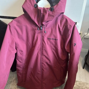 Peak performance  - Peak performance skidjacka näst intill helt ny! Använd kanske 3 gånger i backen. Ser ut som splitter ny. Fodrad och varm. Nypris 3500kr köpt i peak affären i början av året. Färgen är burgundy. Skicka för fler bilder 😃