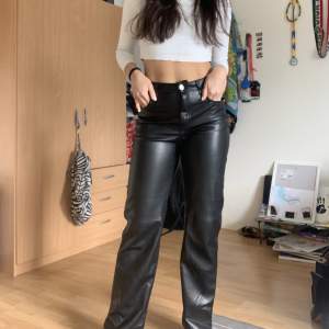 Netsuke faux leather black trousers, with flare look. 