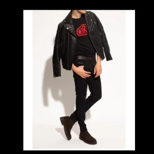 Byxor - Svarta 'D-Strukt' jeans från Diesel. Tillverkat av stretch-bomullsdenim med slim fit, har detta par en gylf med dragkedja och en knapp och klassiska fem fickor. Svart färg. Helt nytt och oöppnad  