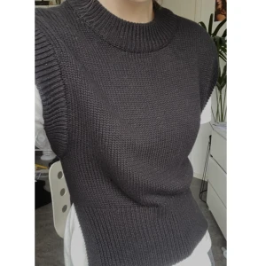 Stickad svart väst  - Stickad svart väst från Gina. Använd en gång. Tjock och varm i tyg och snygg över t-shirts och långärmat. 