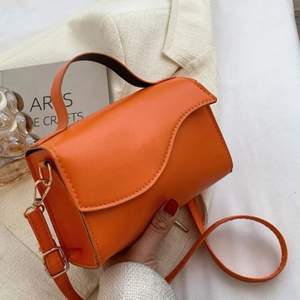 Jättefin liten orange väska! Perfekt till sommaren! Aldrig använd, råkade köpa två av samma så säljer nu den ena! Väldigt trendig väska och färg! 
