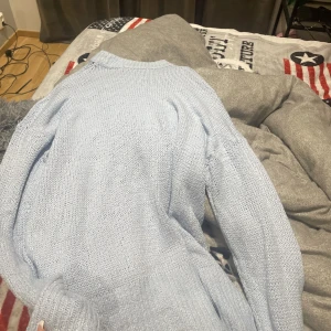 stickad tröja - den e lång i modellen och är ljusblå  använd 3 gånger max 