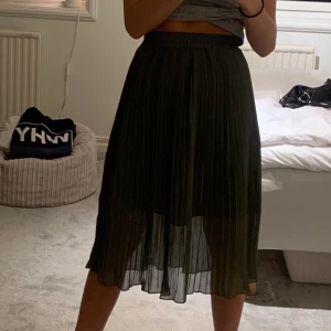 Mörkgrön plisserad långkjol från NAKD - En mörkgrön plisserad långkjol från NAKD! Stl 32 men passar säkert större och mindre med stanke på att det är resår! Säljer pågrund av att den aldrig används och endast är testad en gång, köparen står för frakten! 