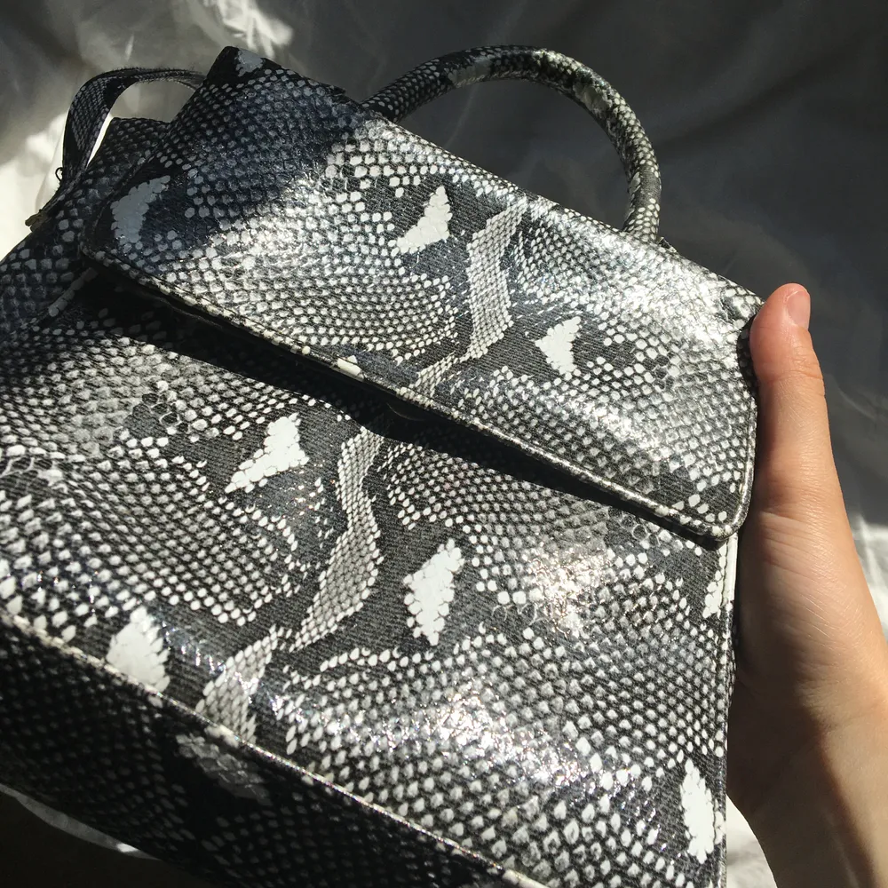 Svinball väska som är i ett läderliknande material med ormskinnsmönster. Väskor.