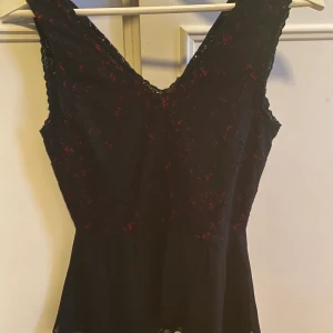 Svart/röd blus i spets - Snygg blus i svart med rött under spetsen.