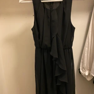 Svart klänning - Svart kortklänning med volang.