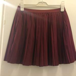 Vinröd, tunn plisserad kjol i bra skick. Frakten ingår i priset och den finns även på fler sidor.