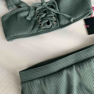  - så fin ribbad bikini från south beach! underdelen är högmidjad. aldrig använd utan endast provad med trosor på, och plomberingen är även kvar på underdelen. överdelen strl 32, underdelen strl 34. spårbar frakt ingår i priset🌸