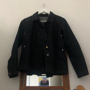 acne jeansjacka - en acne jeansjacka dark wash köpt här på plick men passar tyvärr inte! den är mörkblå/navy med röda sömmar!!! det står storlek m (herrstorlek) men skulle säga att den är lite liten i storleken. jag på bilden är 160. frakt tillkommer :)