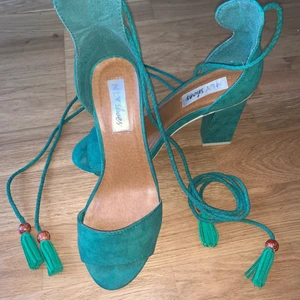 Snygga mocka High hele sandaler - Supersnygga högklackade sandaler i grön mocka immitation med långa snören. Från Nelly shoes. Storlek 37. Använd bara 1 gång, så den är i nyskick. Klack höjd 9 cm. Frakt tillkommer : 55kr. 