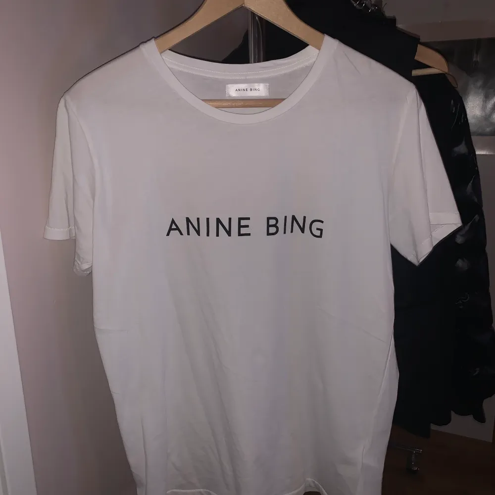 En helt ny vit T-shirt från Anine bing med tryck på både framsida och baksida. Skulle säga att den passar från XS till M beroende på vilken passform man vill ha.  Nypris är 1000 kr och jag säljer för 550 kr + frakt✨🤍. T-shirts.