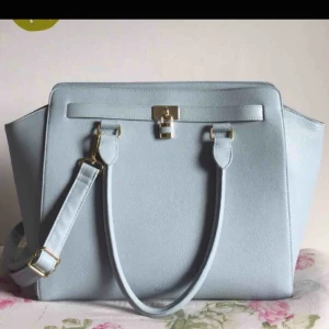  - Jättefin väska från Don Donna som tyvärr aldrig kommit till användning. En rymlig väska som är blå/grå med gulddetaljer. Skinimitation. 