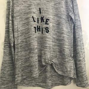 En långärmad tröja med text (I LIKE THIS) från H&M 