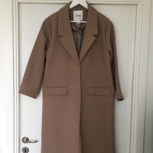  - Läcker kappa från Monki, i sand/camel. Sjukt snygg kappa som aldrig har använts, lappen sitter kvar. Finns i butik nu, nypris 900kr. FYNDA!!😀🙌🏼✨💕